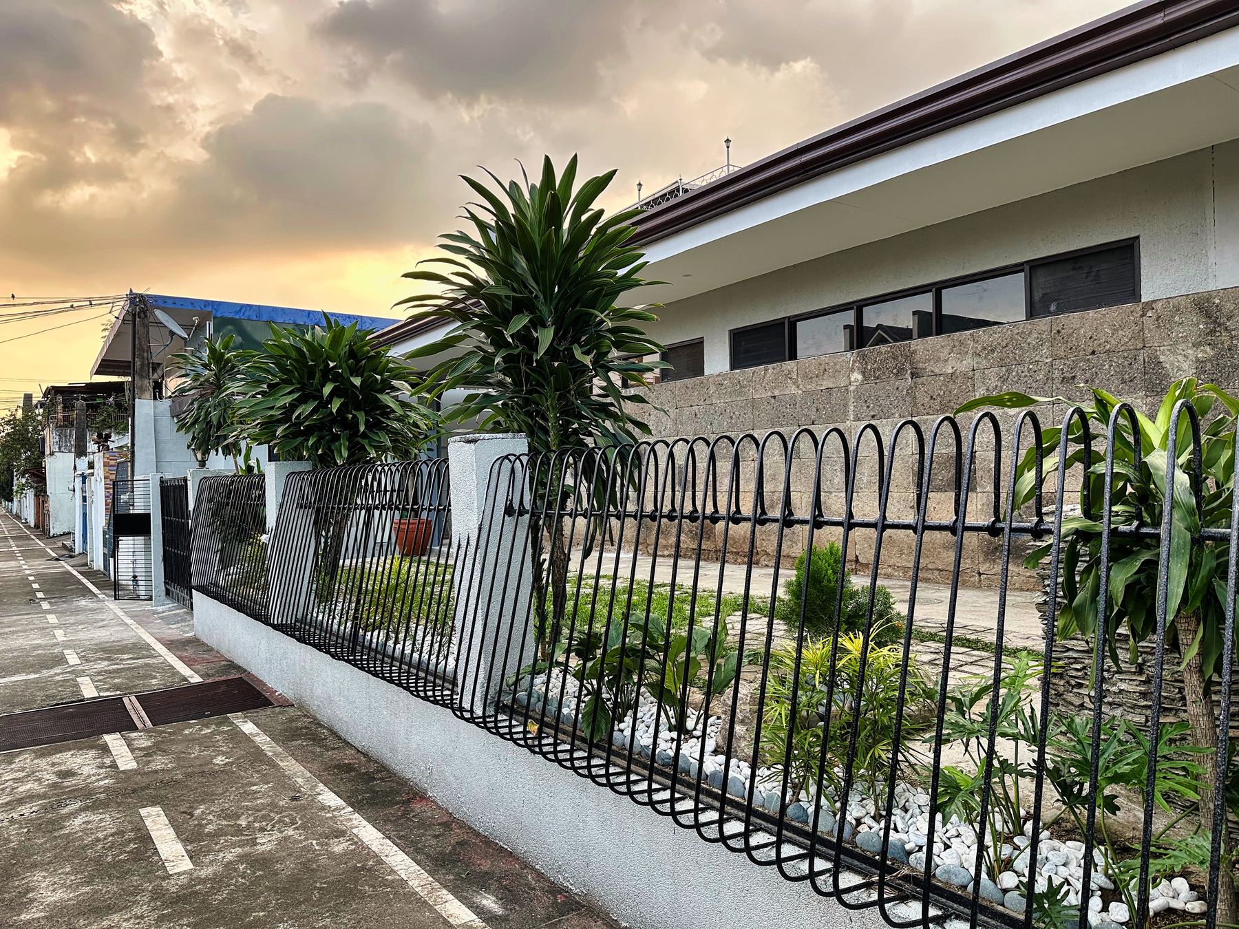 Exterior of the Seniors Living Well facility at sunset, with a landscaped garden